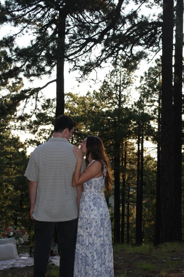 HannahMarie and Trevor looking out through the trees.